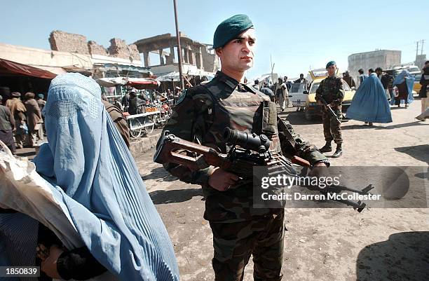 Turkish soldier with the International Security Assistance Force , patrols a market March 15, 2003 in Kabul, Afghanistan. ISAF's main goal is to...