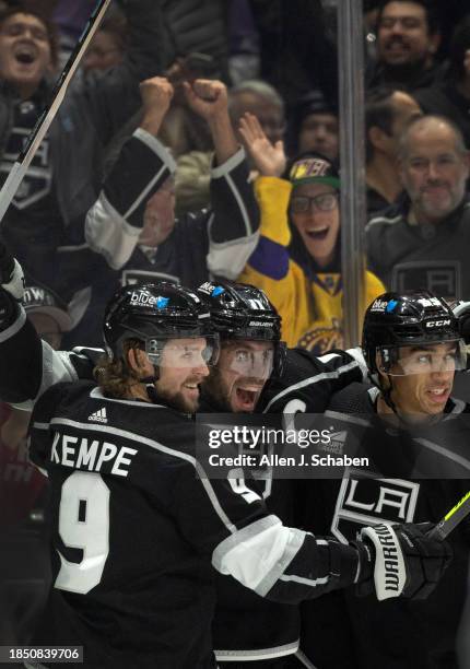 Los Angeles, CA Kings fans and Kings right wings Adrian Kempe, left, and Quinton Byfield, right, celebrate Kings center Anze Kopitar, center, goal...