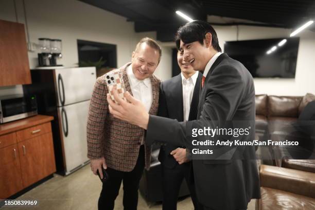 Jung Hoo Lee and his agent Scott Boras and Jeong Moon Lee wait at Oracle Park before a press conference to introduce his contract with the San...