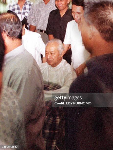 Former Indonesian president Suharto on the wheelchair is pushed by a nurse to the CT scan room at the Pertamina hospital under tight security, in...