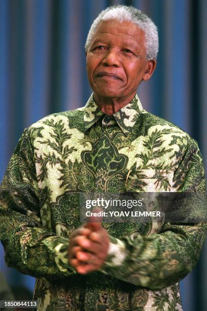 South African president Nelson Mandela claps his hands to gospel music during a sunday prayer at a church in Eldorado park 09 May 1999. Mandela said...