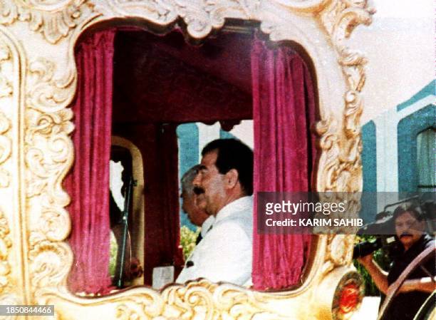 Iraqi President Saddam Hussein sits in a carriage coach 29 April 1993. The coach was presented to him as a gift 29 April 1993 in celebration of his...