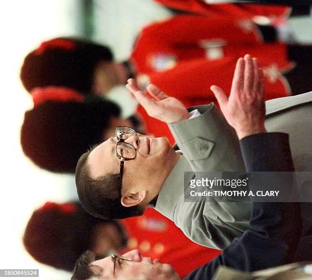 Chinese leader Jiang Zemin walks past the Canadian guard of honor as he arrives at Vancouver airport, Canada, 23 November, for the fifth Asia Pacific...
