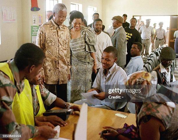 South African President Nelson Mandela and his wife Graca Machel arrive 27 November at the Alexandra township in Johannesburg to meet people who...