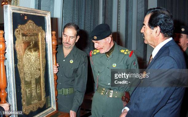 Picture released 02 December by the official Iraqi News Agency INA shows Iraqi President Saddam Hussein and his deputy Ezzat Ibrahim looking at a...