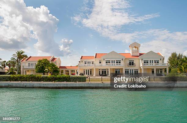 mansion on the water - cayman islands stock pictures, royalty-free photos & images