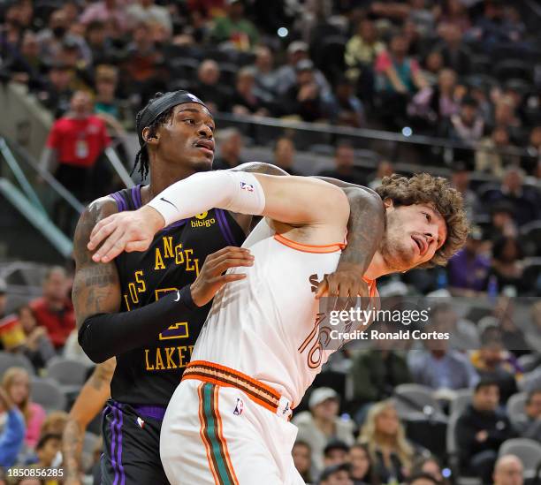 Cedi Osman of the San Antonio Spurs] fights for rebounding position with Jarred Vanderbilt of the Los Angeles Lakers in the first half at Frost Bank...