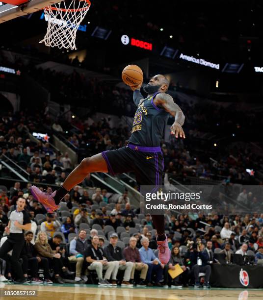 LeBron James of the Los Angeles Lakers dunks against the San Antonio Spurs in the first half at Frost Bank Center on December 15, 2023 in San...