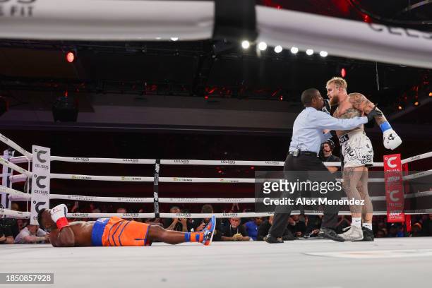 Referee Christoper Young holds back Jake Paul after he knocks out Andre August during the Jake Paul v Andre August at the Caribe Royale Orlando on...