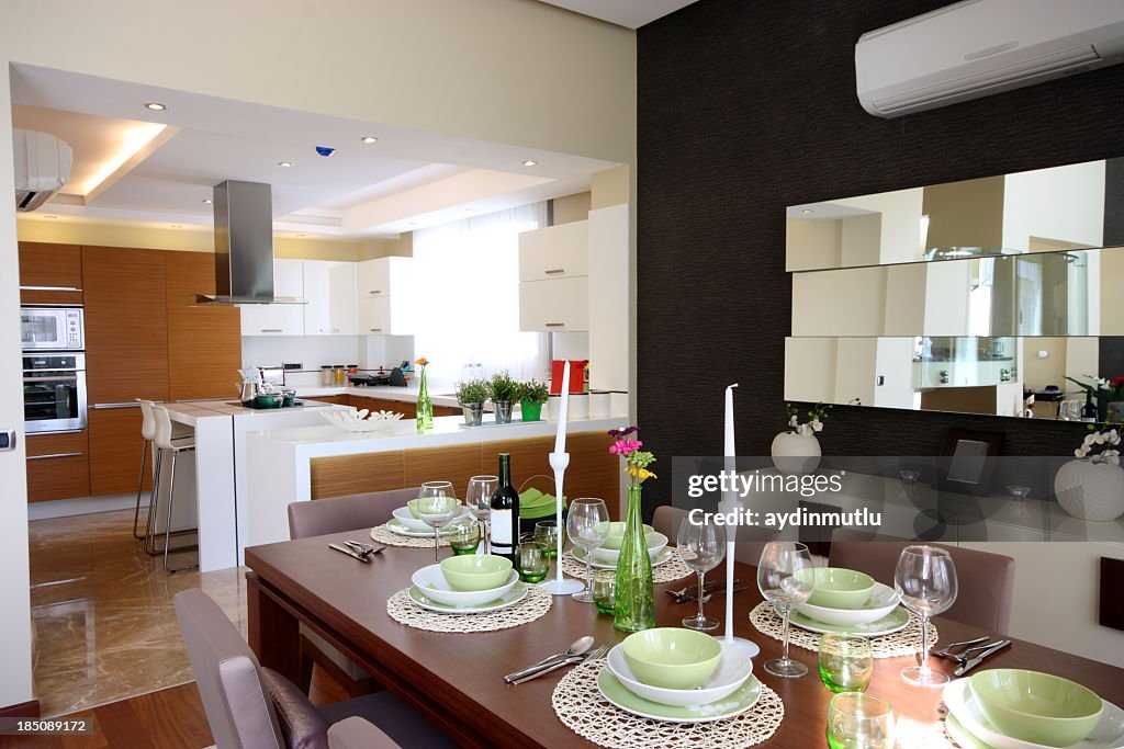 Set dining room table next to kitchen in open concept home