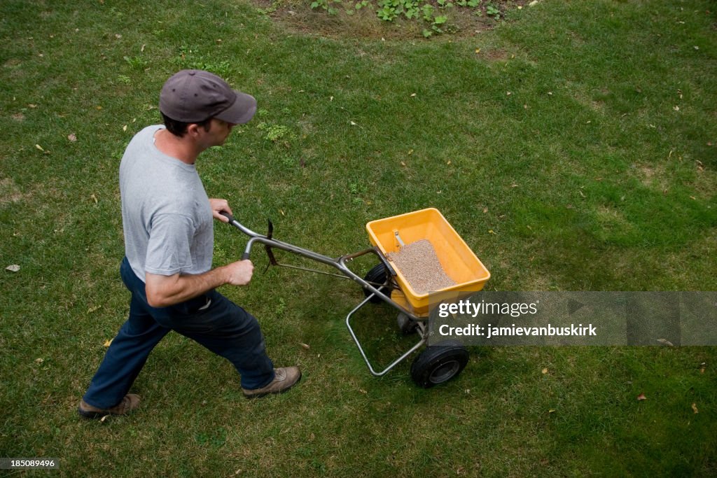 Landscaper Fertilizes a Lawn