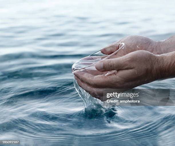 hands and water - religious blessing stock pictures, royalty-free photos & images