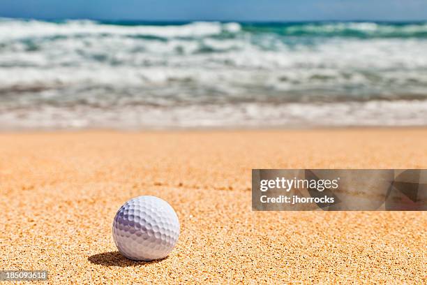 golf ball on beach - golf bunker low angle stock pictures, royalty-free photos & images