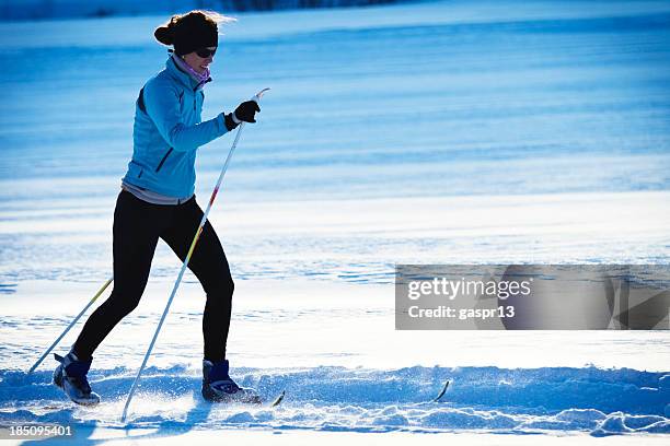 cross country skiing - classic style - female skier stockfoto's en -beelden