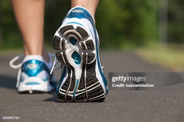 close-up view of sports shoes in mid stride - human foot stock pictures, royalty-free photos & images