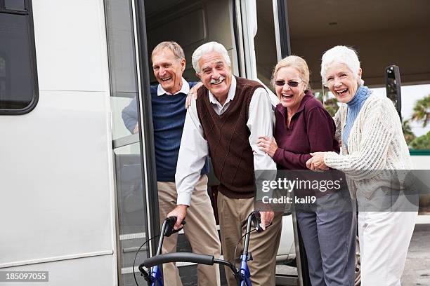 senior couples outside shuttle bus - senior public transportation stock pictures, royalty-free photos & images