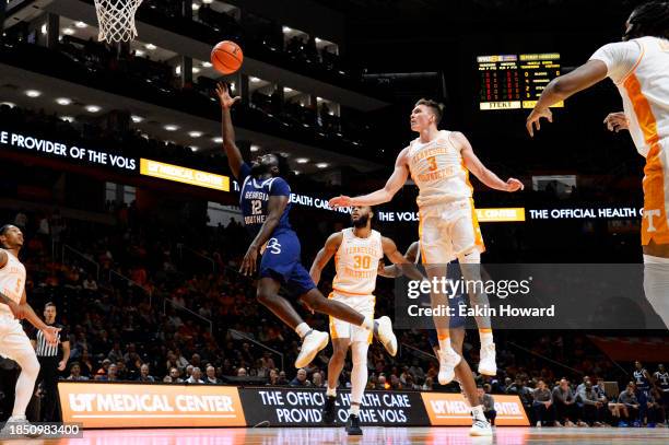 Tyren Moore of the Georgia Southern Eagles attempts a layup against Dalton Knecht of the Tennessee Volunteers in the first half at Thompson-Boling...