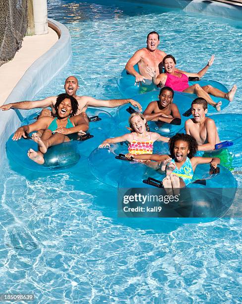 group of people on innertubes at water park - lazy river stock pictures, royalty-free photos & images