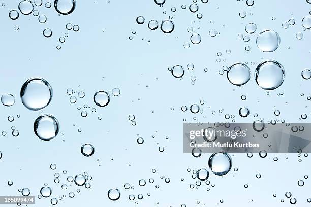 bubbles in clear fresh water on blue background - blue liquid stock pictures, royalty-free photos & images