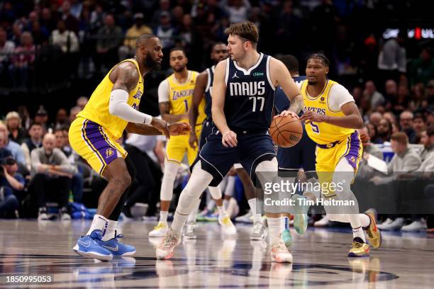 Luka Doncic of the Dallas Mavericks dribbles the ball while guarded by LeBron James of the Los Angeles Lakers in the first half at American Airlines...