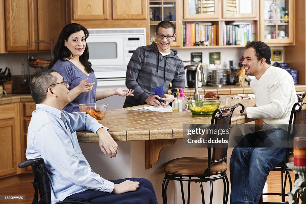 Disabled Man With Family In Kitchen