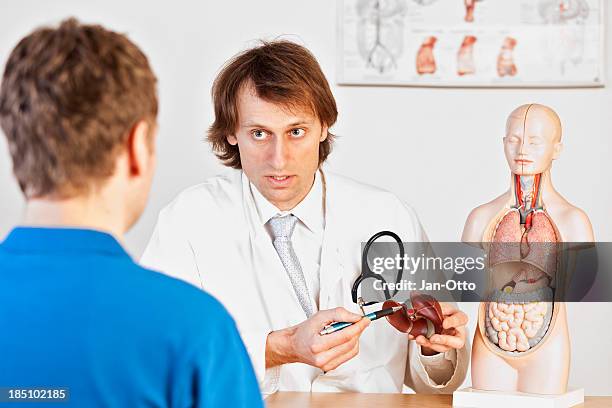 doctor explaining liver problems - patient medical gown stock pictures, royalty-free photos & images