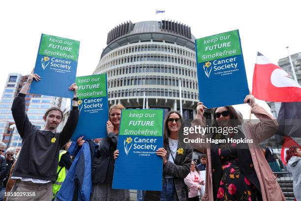 Protestors holds signs during an anti-tobacco protest at Parliament on December 13, 2023 in Wellington, New Zealand. The incoming National Party-led...