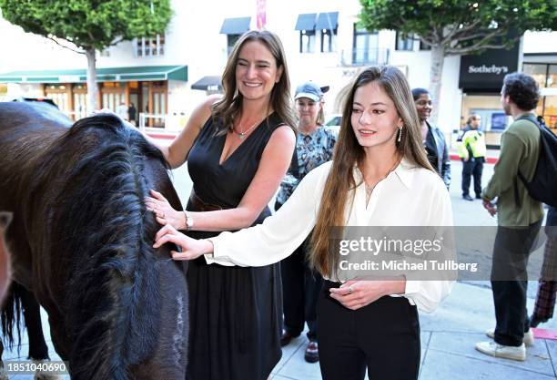 Director Ashley Avis and actor Mackenzie Foy admire Pinson the mustang at a Los Angeles FYC screening of "Wild Beauty: Mustang Spirit of the West" at...
