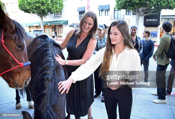 Director Ashley Avis and actor Mackenzie Foy admire Pinson the mustang at a Los Angeles FYC screening of "Wild Beauty: Mustang Spirit of the West" at...