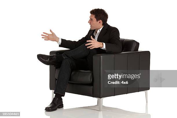 businessman sitting in armchair - armchair isolated stock pictures, royalty-free photos & images