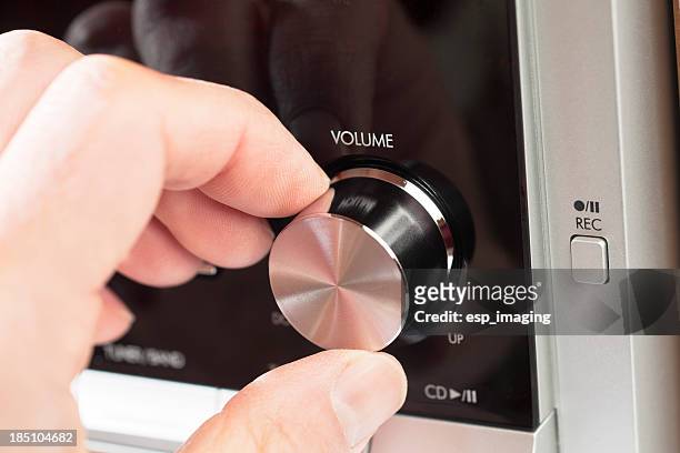 turning the volume knob on a hi fi - pivot stock pictures, royalty-free photos & images