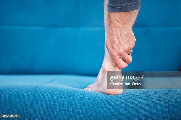 pain in achilles-tendon - man feet stockfoto's en -beelden