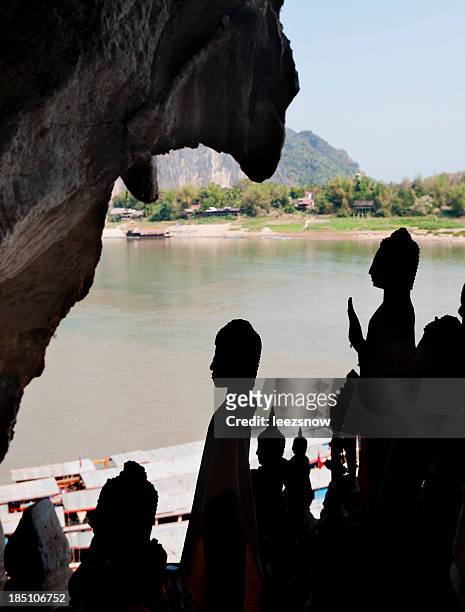 buddha statues silhouette - pak ou caves stock pictures, royalty-free photos & images
