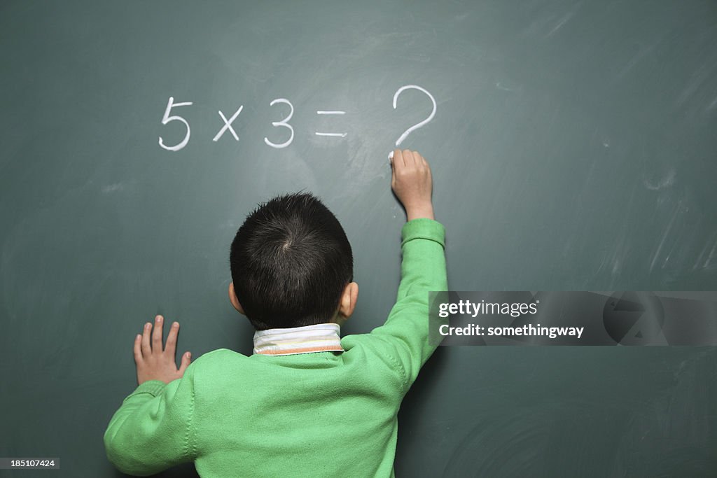 One boy is doing the math question