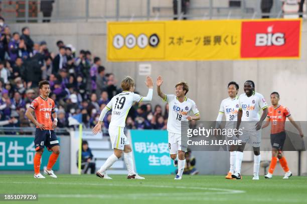 Yoshifumi Kashiwa of Sanfrecce Hiroshima celebrates with teammate Sho Sasaki after scoring the team's fourth goal during the J.League J1 first stage...