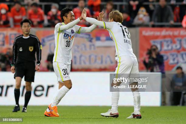 Kosei Shibasaki of Sanfrecce Hiroshima celebrates with teammate Sho Sasaki after scoring the team's fifth goal during the J.League J1 first stage...