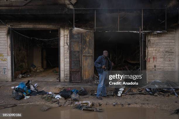 People are around a destroyed house which has walls covered with burn marks due to highly flammable explosives Israeli forces use in attacks at the...