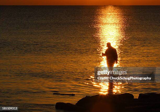 fisherman silhouette sunrise lake - surf casting stock pictures, royalty-free photos & images