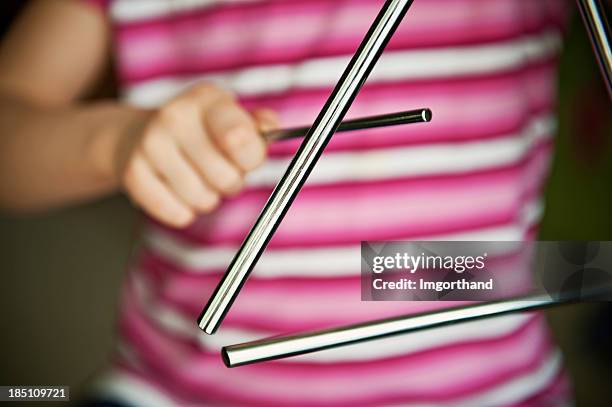 niño jugando triangle - kids instruments fotografías e imágenes de stock