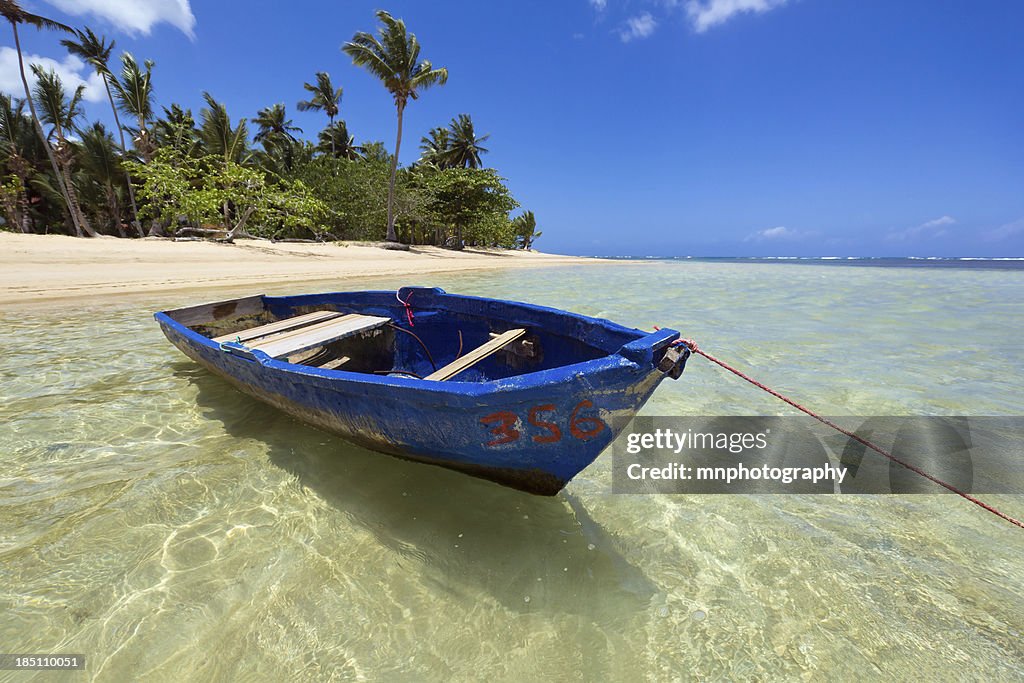 "A close up, wide angle photo of a fiberglass fishing boat in the sparkling waters of the Carribbean Sea.  Photo taken in the Dominican Republic."