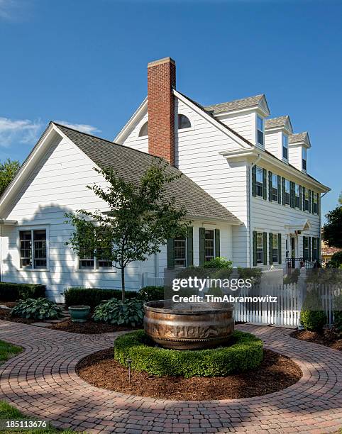 white, colonial style house with landscaping on a clear day - brick pathway stock pictures, royalty-free photos & images