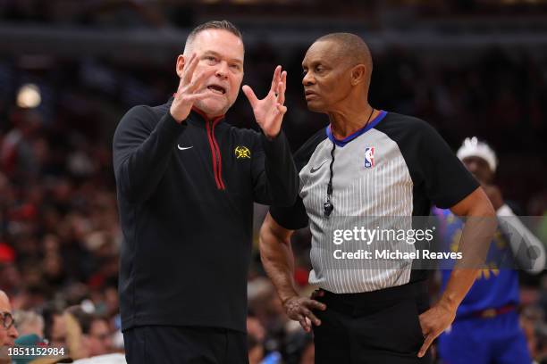 Head coach Michael Malone of the Denver Nuggets argues with referee Michael Smith against the Chicago Bulls during the first half at the United...