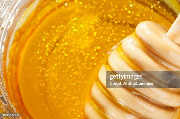 wooden drizzler over pure golden honey with copy space - manuka honey stock pictures, royalty-free photos & images