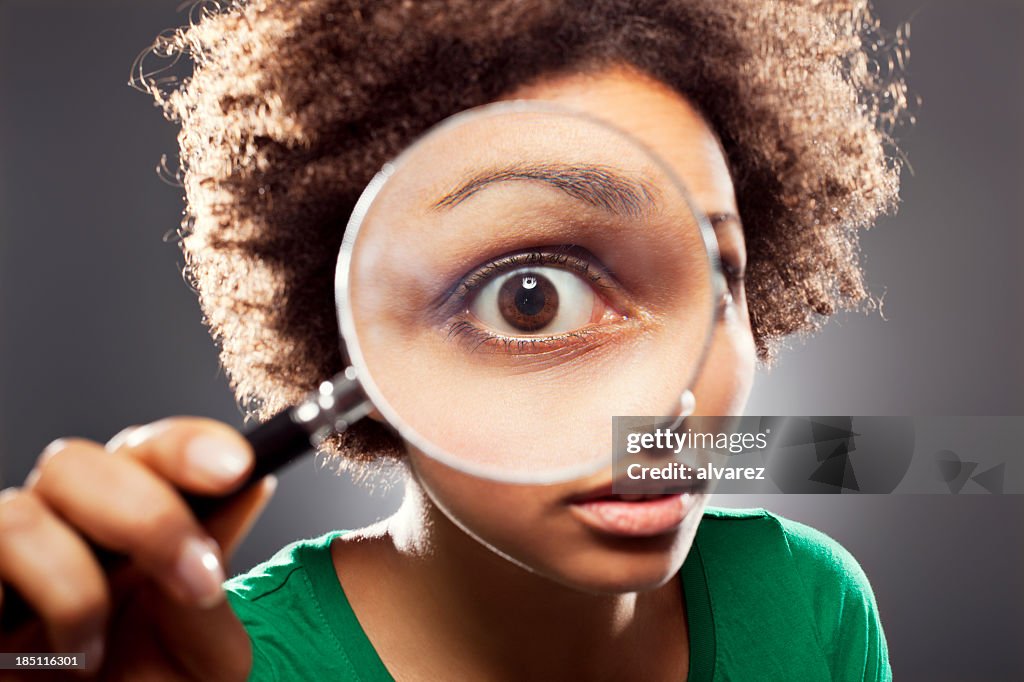 Young woman with a loupe