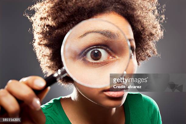 young woman with a loupe - magnifying glass stock pictures, royalty-free photos & images