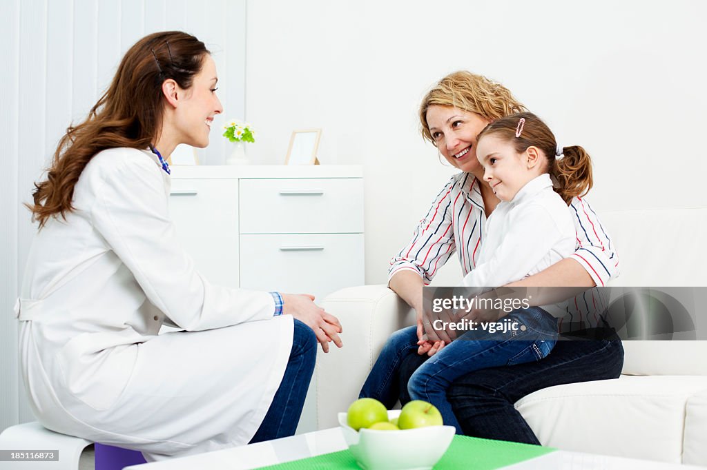 Pediatrician talking to mother and child