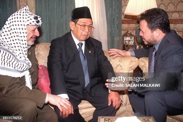 King Abdallah II of Jordan and Palestinian President Yasser Arafat hold talks with Indonesian President Abdurrahman Wahid at the Royal Palace in...