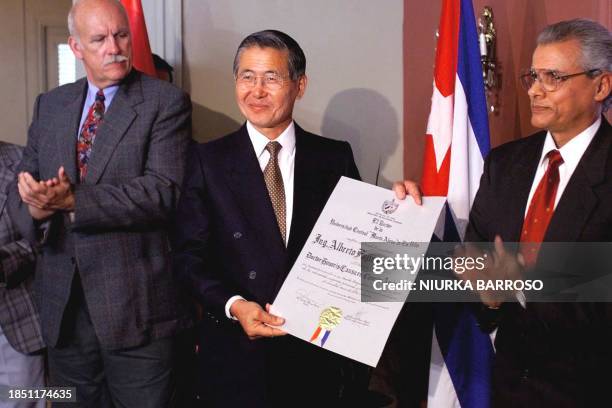 President of Peru Alberto Fujimori , acompanied by the Minister of Superior Educacion of Cuba, Fernando Alegret and of the Director of the Central...