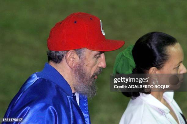 Cuban President Fidel Castro , dressed in red and blue heads to the field to open the baseball game between Cuba and Venezuela, 18 November 1999 in...