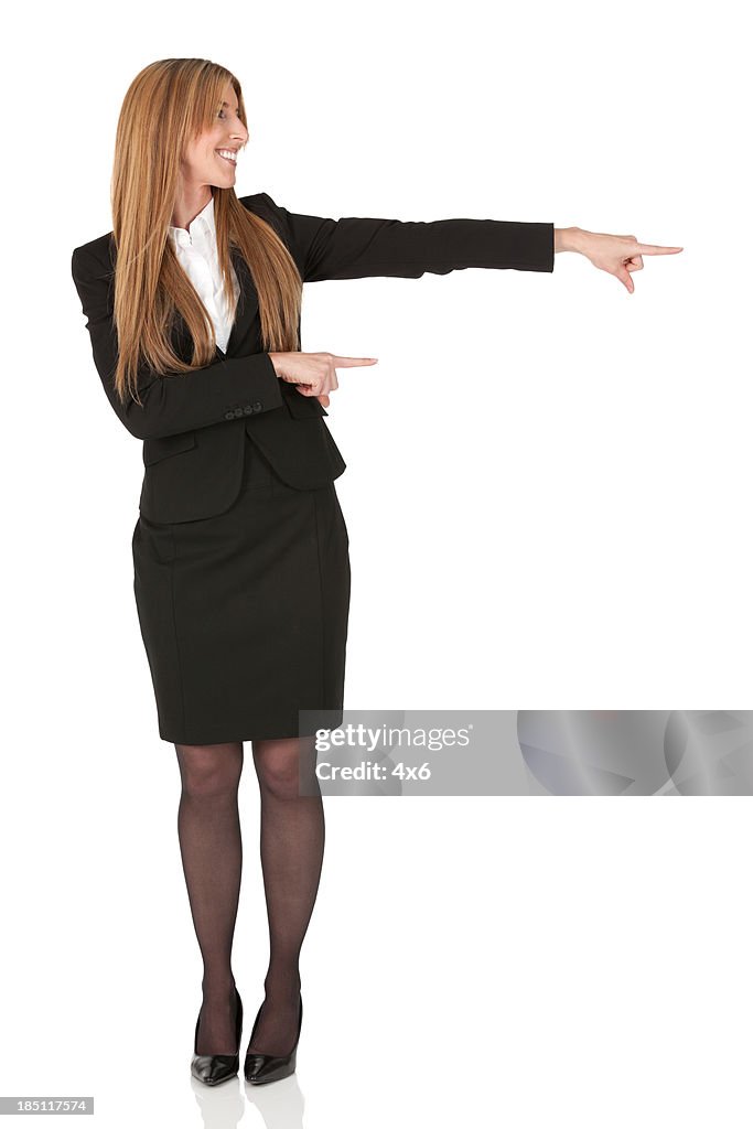 Businesswoman pointing sideways